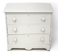 A grey painted chest of pine drawers. Three long graduated drawers with turned handles.