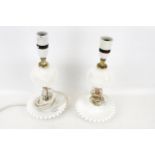A pair of milk glass table lamps.
