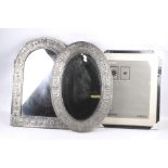 Two Indian pewter framed mirrors and a contemporary picture frame.