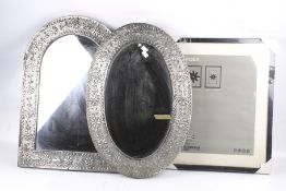 Two Indian pewter framed mirrors and a contemporary picture frame.