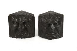 A pair of carved wooden bookends. Signifying 'Happy' and 'Sad', signed 'E R' to the reverse, Max.