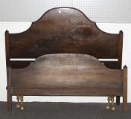 A vintage double bed frame with mahogany ends.