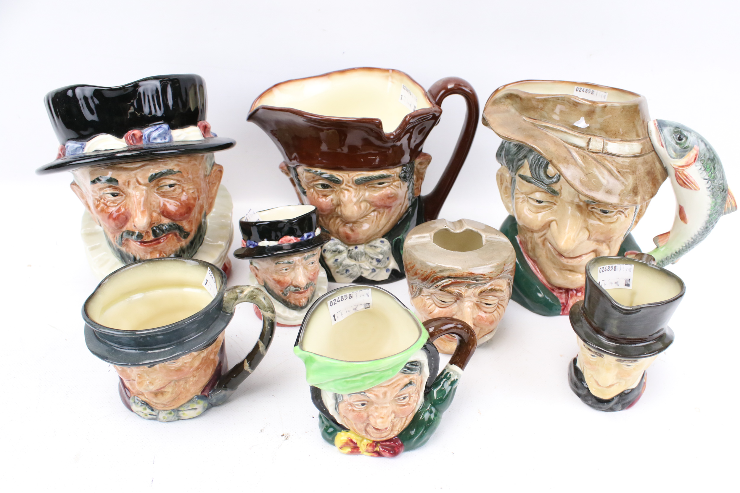 Seven Royal Doulton character jugs and an ashtray.