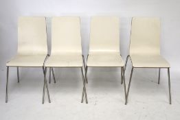 A set of four contemporary cream plywood stacking dining chairs.