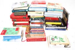 A large collection of hardback and paperback books.