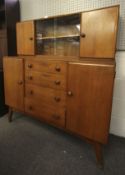 A Mid century oak sideboard with drawers.