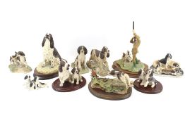 Nine Border Arts Spaniel dog figures. Modelled in various poses, some mounted on wooden bases, Max.