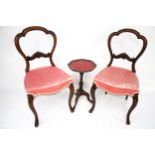 A pair of Victorian balloon back chairs and a wine table.