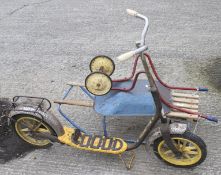 A vintage toy scooter, sledge and wheelbarrow.