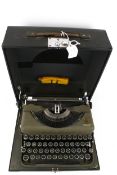 A vintage Imperial Model T portable manual typewriter. In a black carry case, L33.