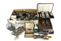 A box of assorted silver plate and metalware.