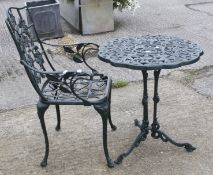 A contemporary cast metal carved table and chair.