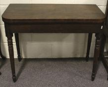 A late 18th/early 19th century mahogany card table with revolving top.