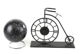 A penny farthing bike shaped clock and a retro black world globe on chrome base. Max.