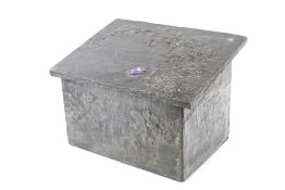 A vintage coal box with embossed flowers.