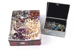An assortment of costume jewellery. Including imitation pearl necklaces, pendants, etc.
