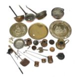 An assortment of copper and brassware. Including pans, trays and a candlestick, etc.