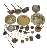 An assortment of copper and brassware. Including pans, trays and a candlestick, etc.