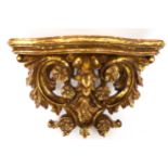 A contemporary gilt wall bracket. Decorated with flowers.