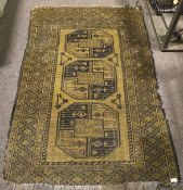 A kilim style black and brown rug.