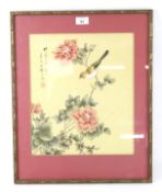 An oriental silk picture of birds and blossom.