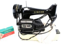 A Singer 99K electric sewing machine and accessories. S/n.