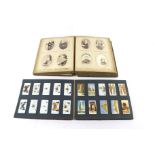 A Victorian photograph album and a collection of cigarette cards.