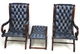 A pair of blue button back open armchairs and a matching foot stool.