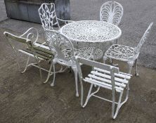 A cast metal garden table and six chairs.