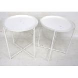 A pair of Ikea white metal bedside circular tables.