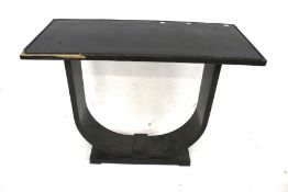 A 20th century console table. Painted black with a shaped support, H85cm x W104.
