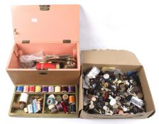 An assortment of buttons and sewing items. Including threads, tape measures, thimbles, etc.
