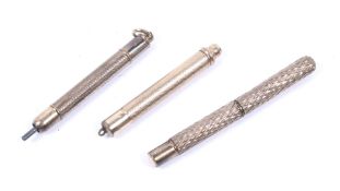 Three propelling pencils. Each with textured details to the exterior, L7.