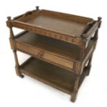 An Adam Bede oak tone drawer tea trolley. With removable tray, on original casters, H72.
