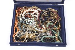 An assortment of ladies vintage jewellery contained within a blue velvet box.