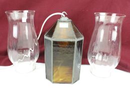 A pair of oil lamp shades and ceiling light.
