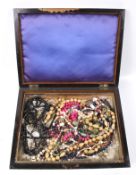 A box of costume jewellery. Including imitation pearls, wooden beads, etc.
