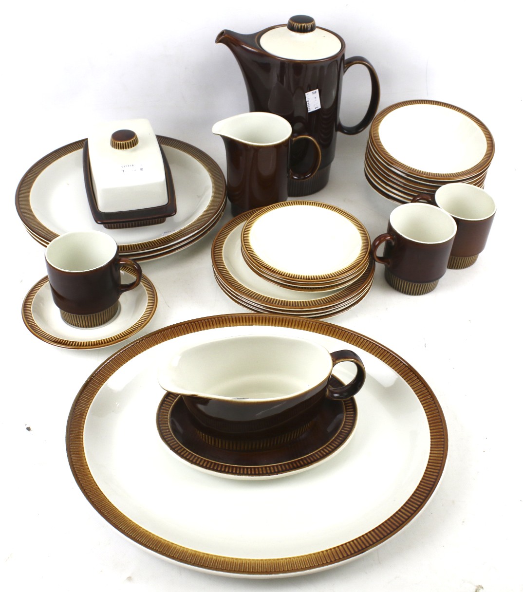 A Poole tea and dinner service. Including a teapot, cups and saucers, butter dish, etc.