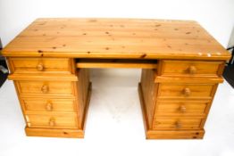 A contemporary pine twin pedestal desk.