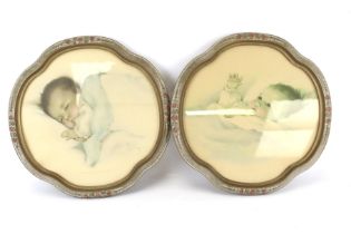 A pair of framed prints of babies by Betty Pease.