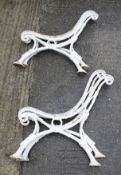 Two pairs of cast metal bench ends.