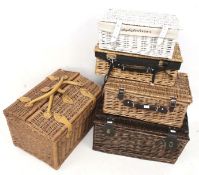 Five assorted wicker baskets, one converted into a pet carrier.