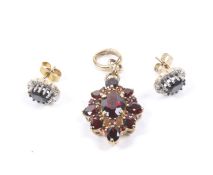 A garnet oval cluster pendant and a pair of sapphire and diamond oval cluster stud earrings.