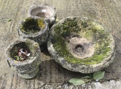 Four composite stone garden pots.