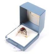 A 9ct gold and oval garnet single stone ring.