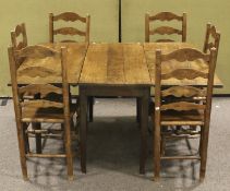 A vintage oak drop leaf table and a set of six ladder back chairs.