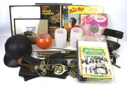 An assortment of collectables. Including a vintage motorbike helmet, LP records, prints, etc.