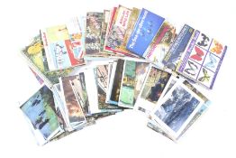 An assortment of cigarette cards and postcards.