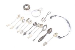 An assortment of silver, white metal and silver plate. Including spoons, a keyring, handle, etc.