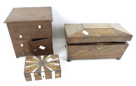 A 20th century tea caddy and two boxes. The tea caddy of sarcophagus form, raised on bun feet, H17.